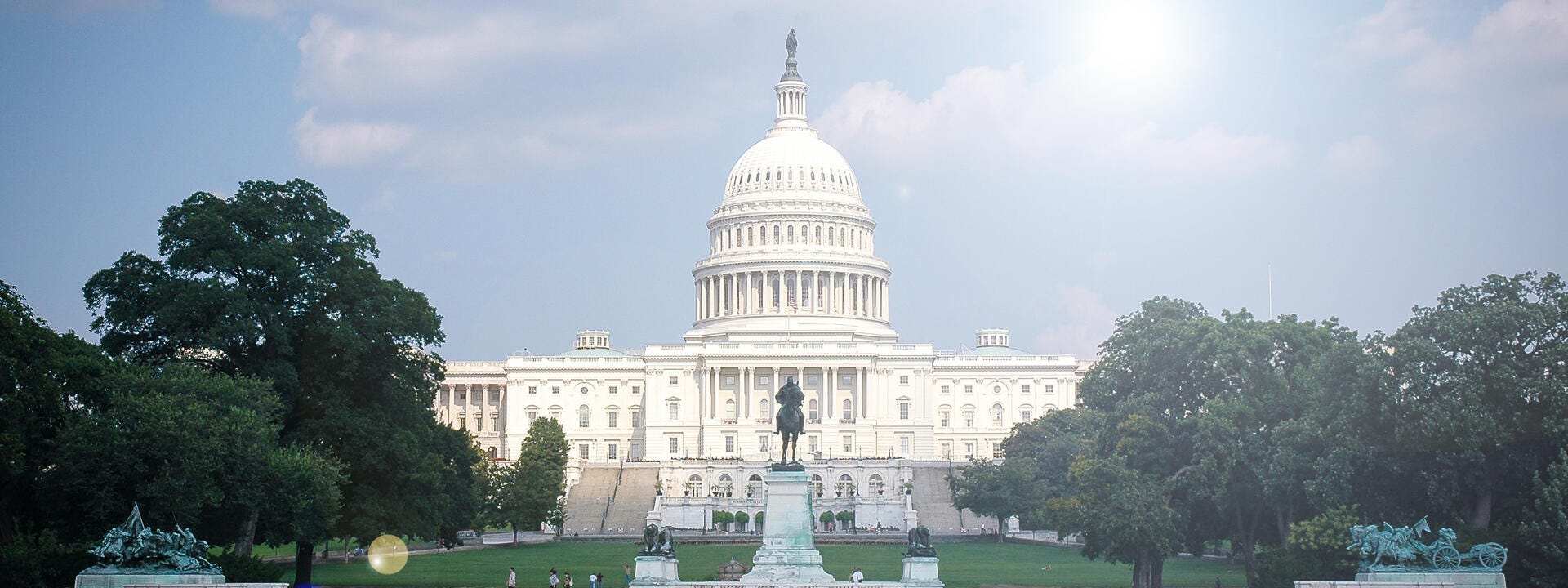 a white building with a dome and a fountain in front of it