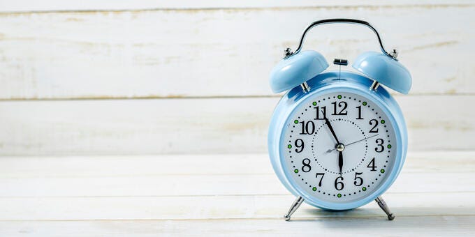 a clock with a kettle on top