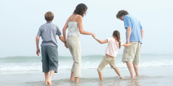 a family walking on the beach