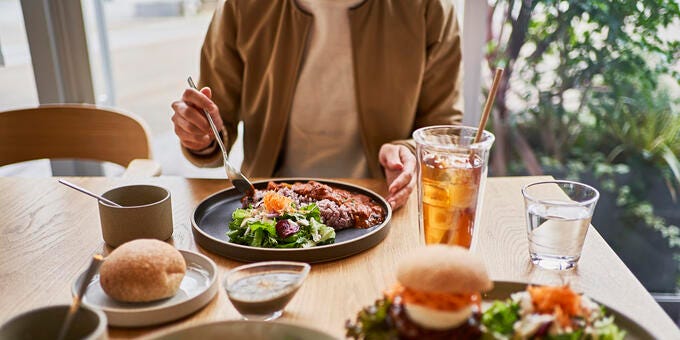 a person eating a meal at a table