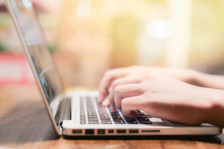 a person typing on a laptop