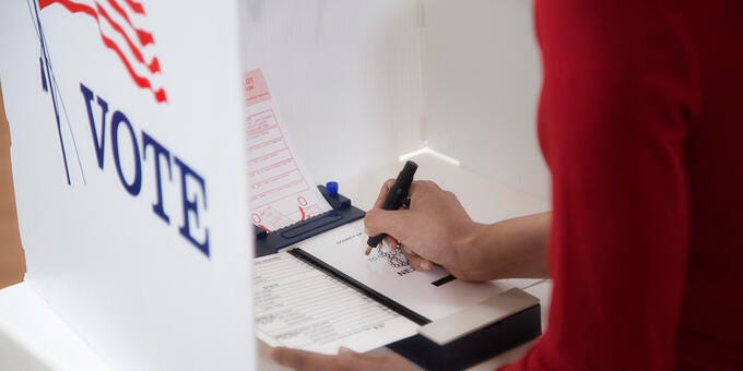 a person writing on a whiteboard