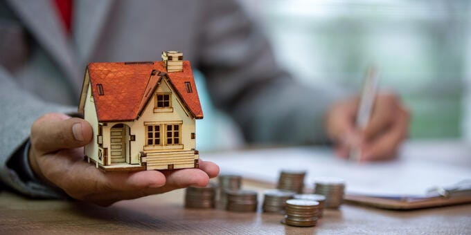 a person holding a small house