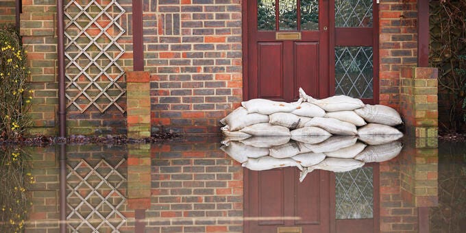 a brick building with a door and a blanket from the window