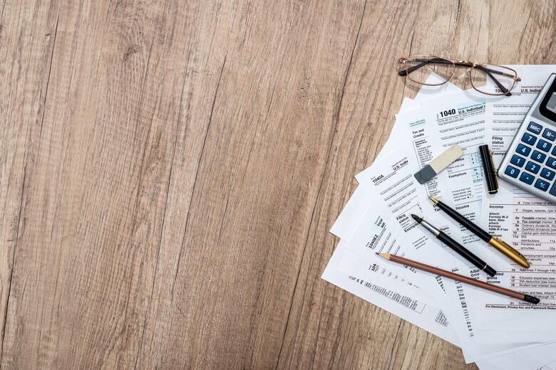 a close-up of a calculator and a pen on a table