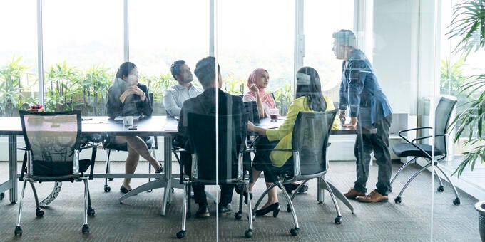 a group of people sitting around a table