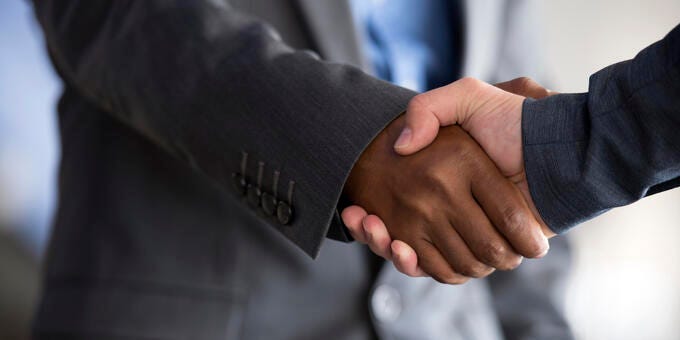 a close-up of people shaking hands