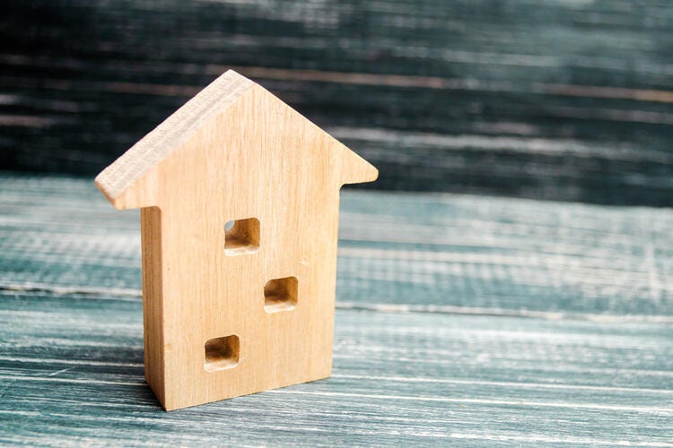 a wooden birdhouse on a table