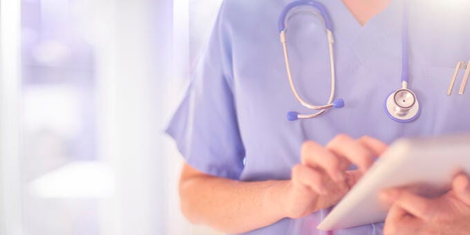 a doctor using a stethoscope to check a patient's pulse