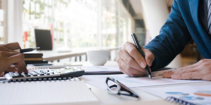 a person writing on a piece of paper