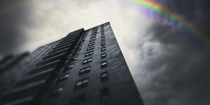 a rainbow over a tall building