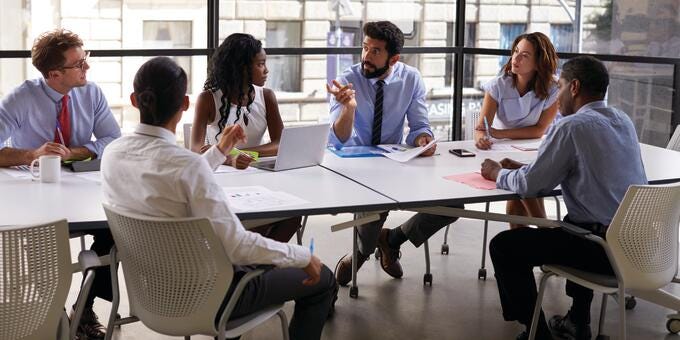 a group of people sitting around a table