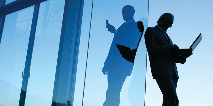 a man and a woman looking at a large window