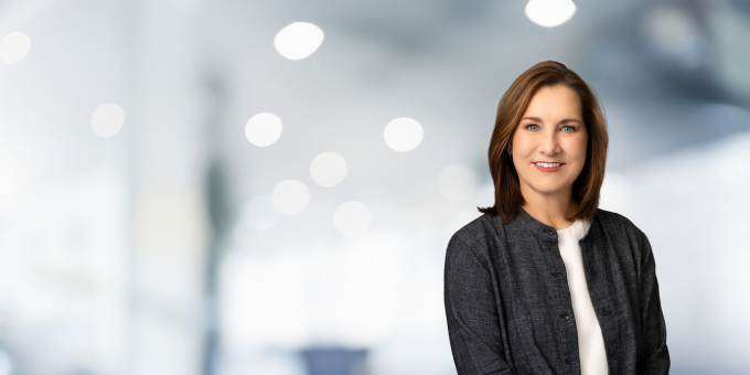 a person smiling in front of a white background